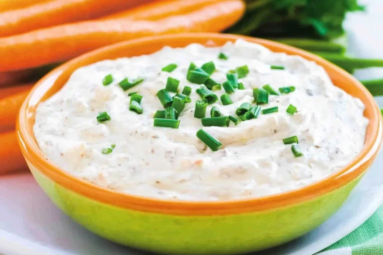 Bowl of homemade onion dip with chips on the side