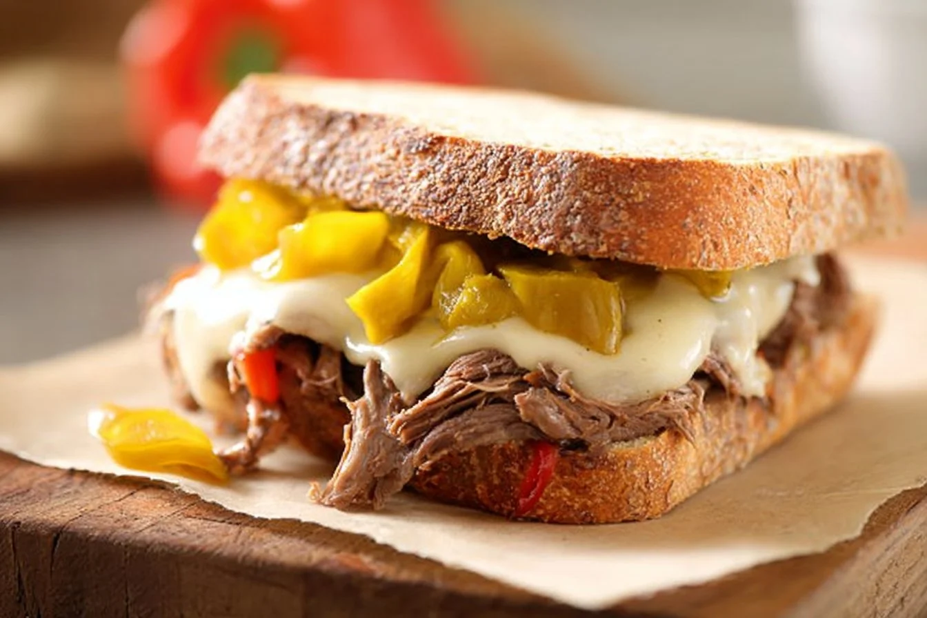 Slow Cooker Italian Beef Hoagies served on a plate with toppings